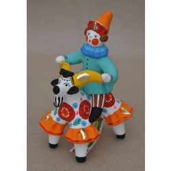 Дымковская глиняная игрушка / Figurine "Skomorokh on a circus goat in a blue sweater"