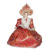 Porcelain doll maker in red dress