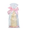 Sculpture of white chocolate "Bottle" with a pink ribbon